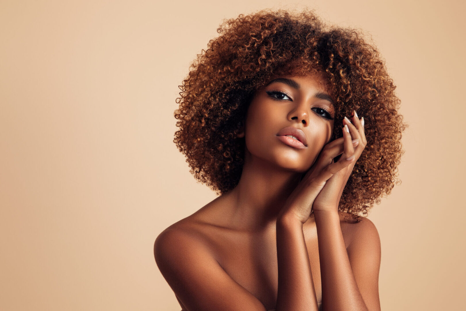 A woman with curly hair posing for the camera.