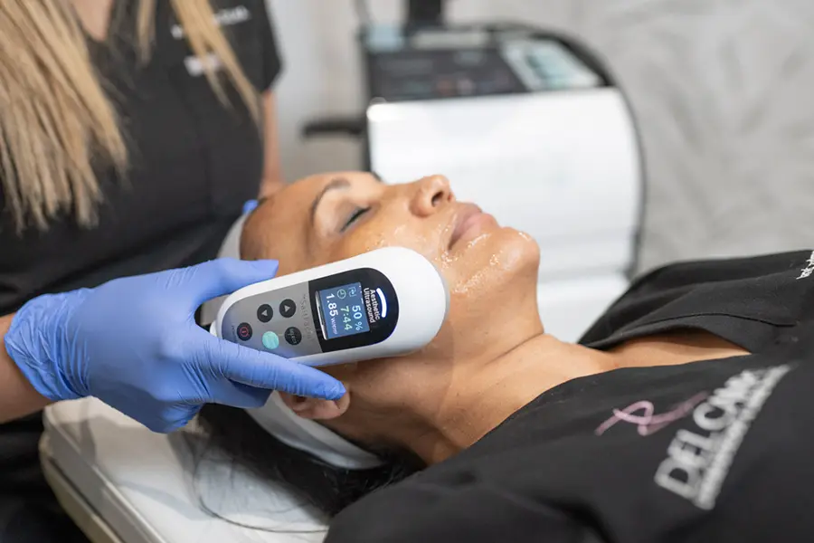 A woman getting her face scanned for skin care.