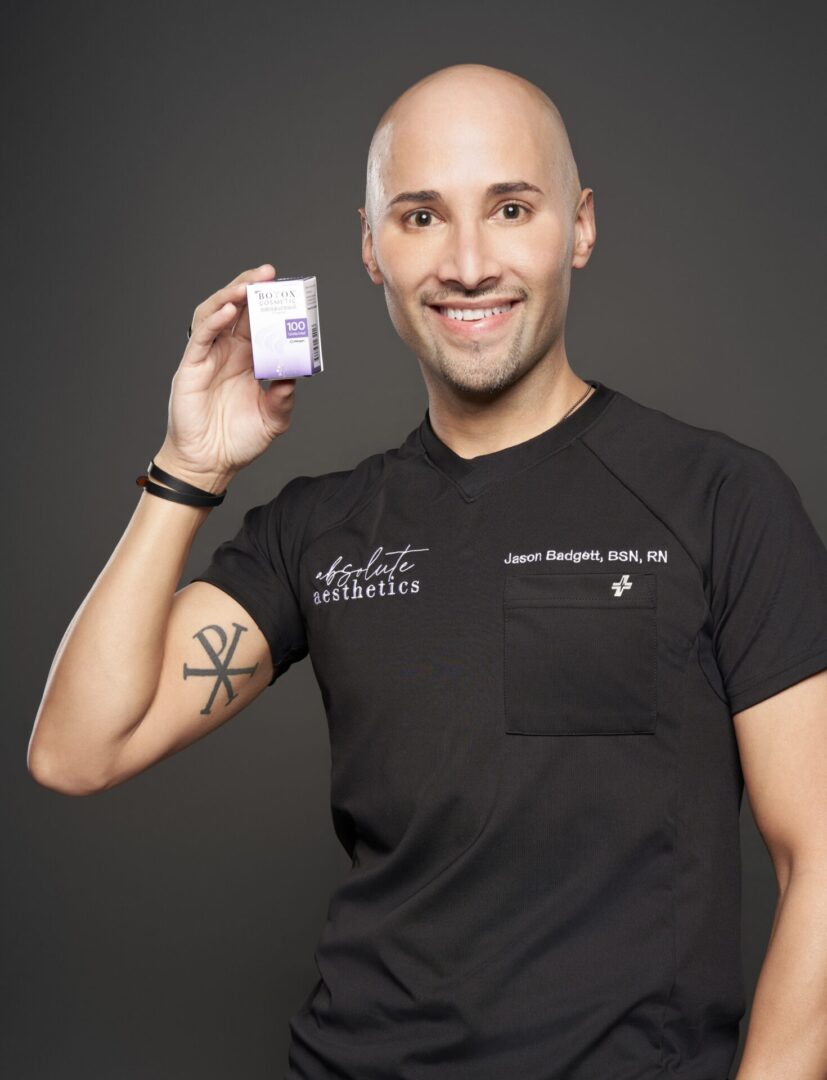 A man holding up a box with a tattoo on it.